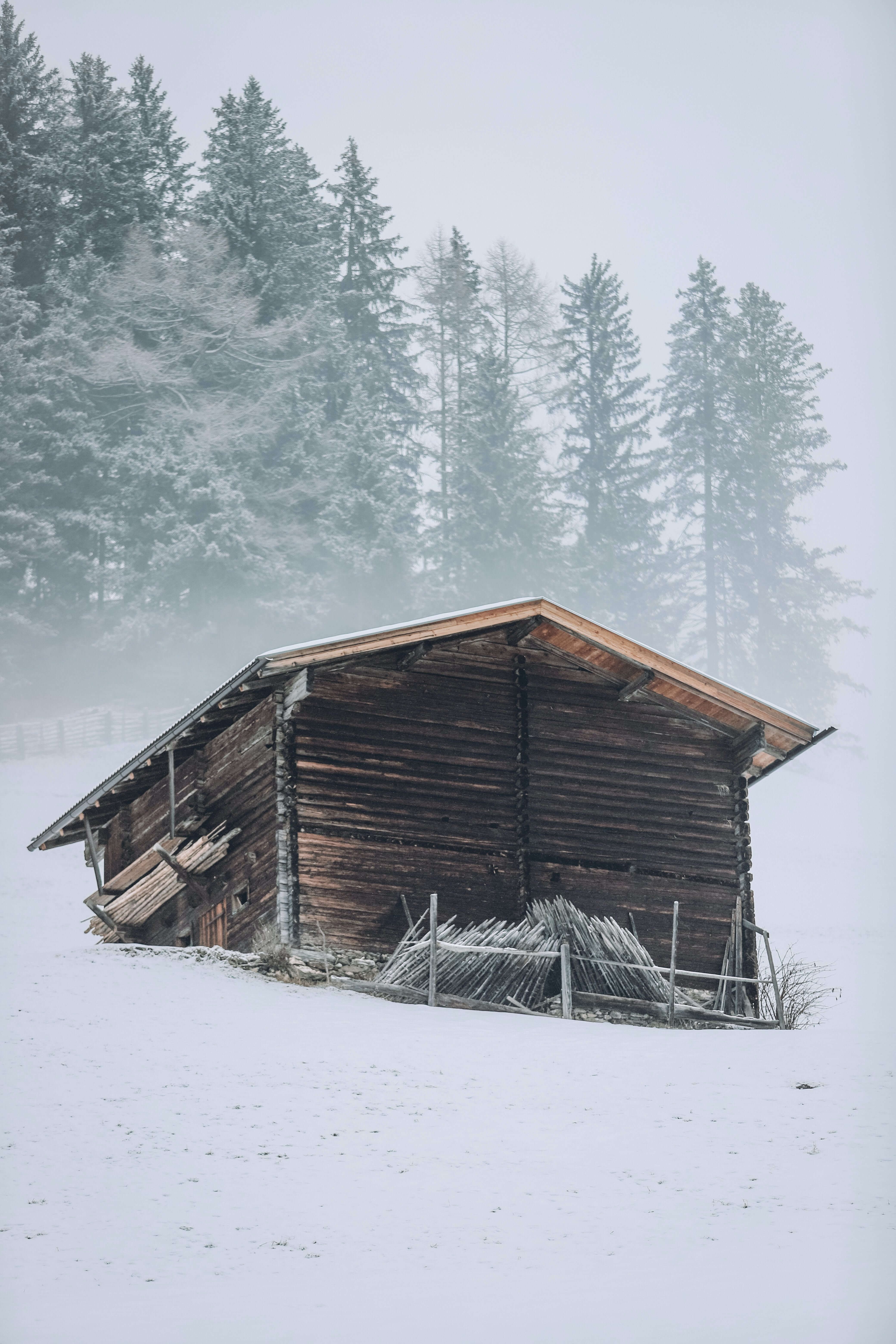  A wooden cabin on a snowy, blizzard Mountain